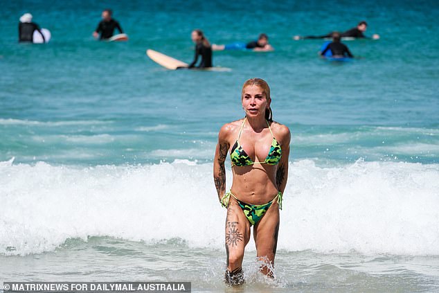 A Sydneysider leaves the surf after enjoying the cool water at Bondi Beach on Sunday