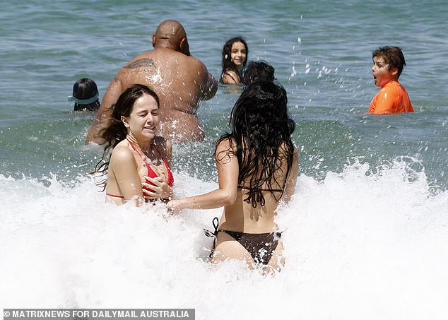 Friends and families enjoyed a splash in the water at beaches across the city, which sweltered in the scorching October heat