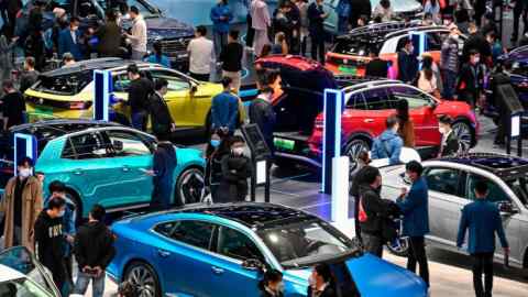 Visitors look at Volkswagen electric vehicles at the Guangzhou International Automobile Exhibition