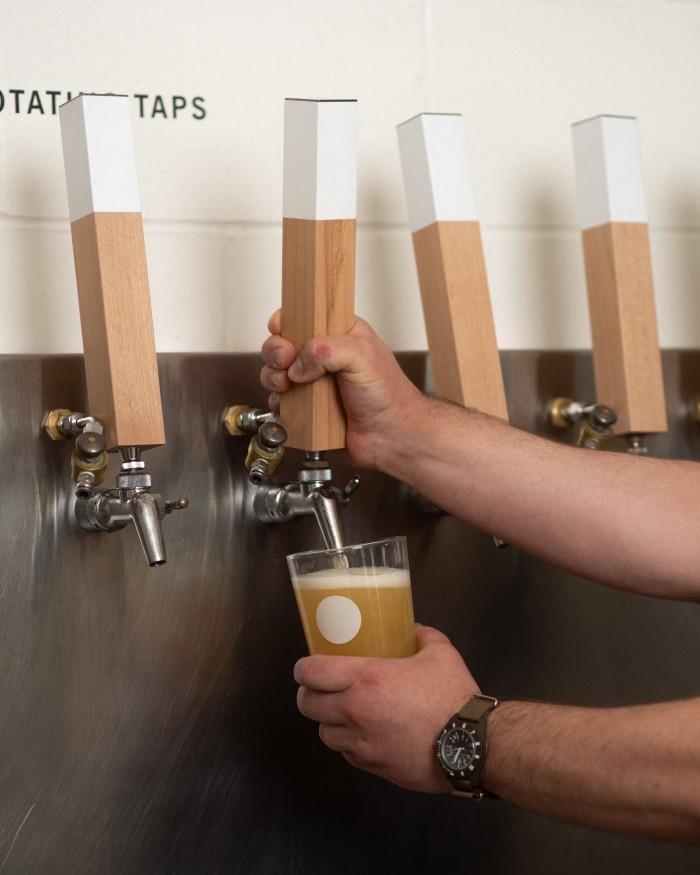 A man pouring a draught beer in 33 Acres