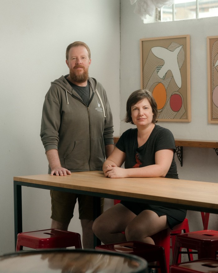 Callister founders Chris Lay and Diana McKenzie at a table in the brewery