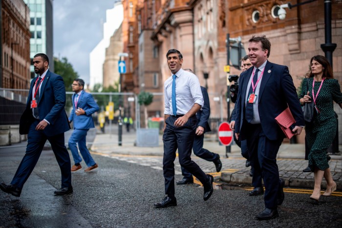 Rishi Sunak walking to the conference hall with aides