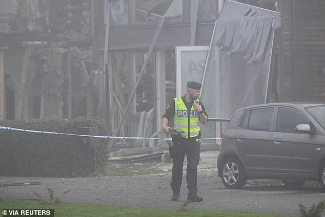 Police are seen outside of Soha Saad's home after an explosion tore through it early Thursday