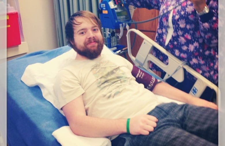 Cody Jordan smiles in a hospital bed as a nurse prepares him for the procedure.