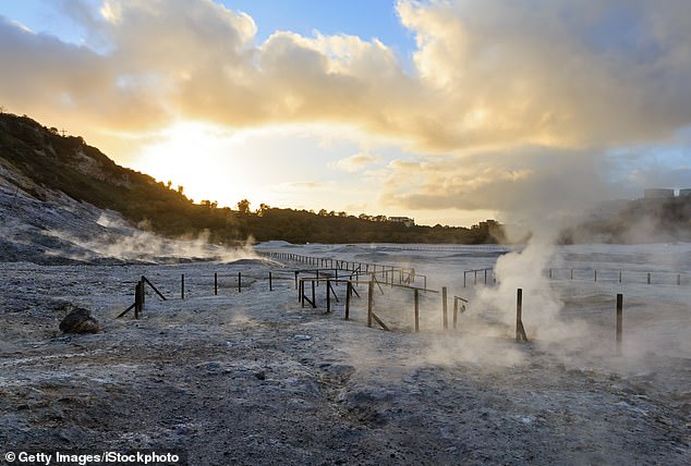 The Solfatara is a shallow volcanic crater with steam with sulfurous fumes