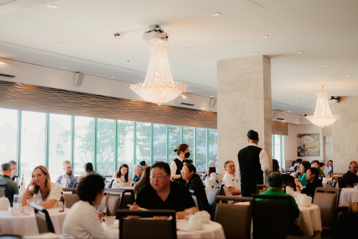 The dining room at Dynasty, filled with guests, and the view through the window obscured by mist