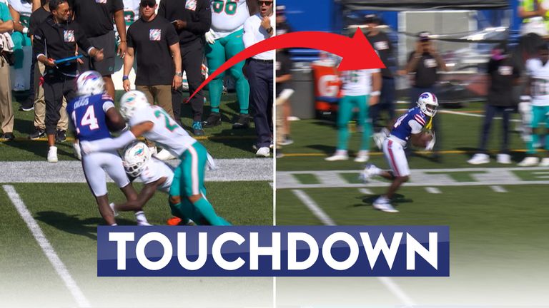 Buffalo Bills' Stefon Diggs spins out of the clutches of two Miami Dolphins defenders before making it to the endzone for a touchdown