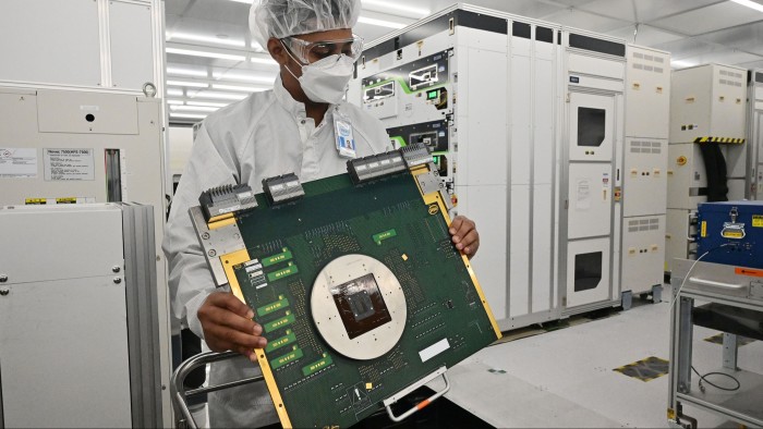 A Malaysian worker holding a computer component