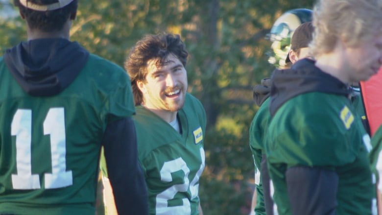 A football player in a green jersey. 