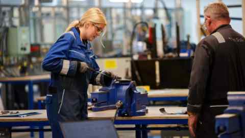 Two workers at a bench