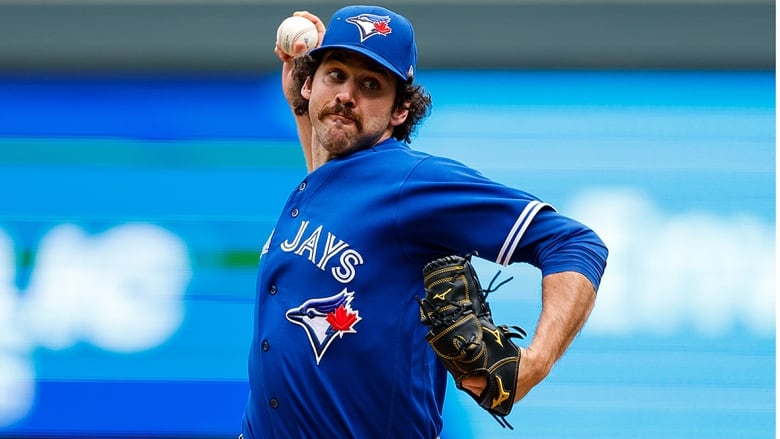 Men's baseball player delivers pitch during major league game.