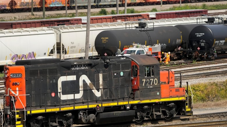 A freight train in a railyard.