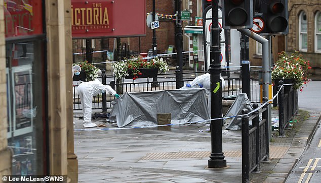 Halifax stabbing: Horrified locals express ‘disgust’ after man is knifed to death while two others are rushed to hospital – as large police cordon is set up amid hunt for attackers