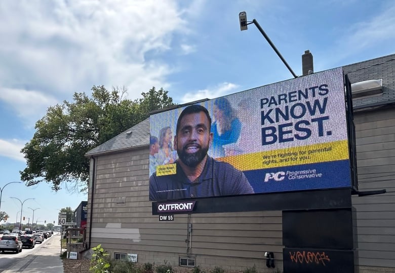 A billboard featuring the face of a Obby Khan with the words "Parents know best."