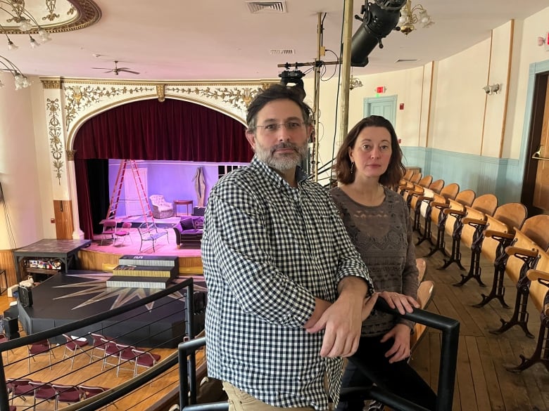 A man and woman on the second floor of an ornate old theatre