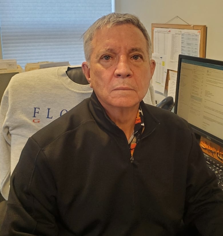 Late-middle-aged man seated at desk