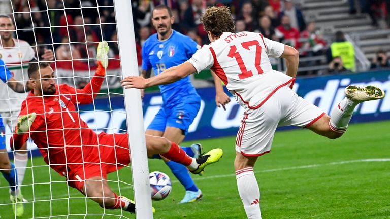 Italian goalkeeper Gianluigi Donnarumma, left, in action against Hungary&#39;s Callum Styles, right, during the UEFA Nations League soccer match between Hungary and Italy, at the Puskas Arena in Budapest, Hungary, Monday, Sept. 26, 2022. (Tamas Kovacs/MTI via AP)