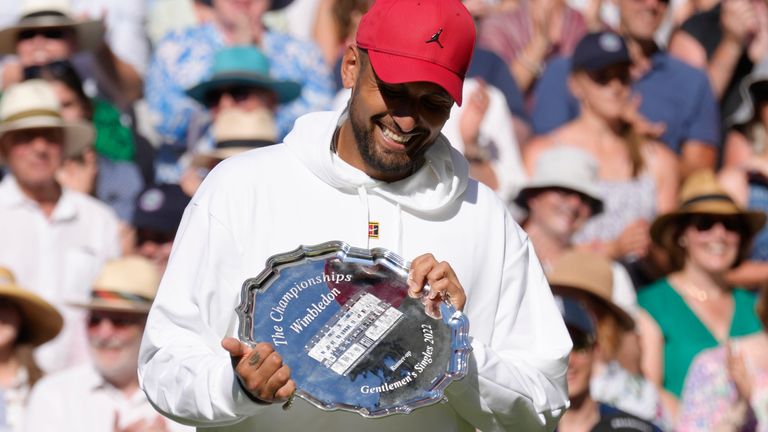 Nick Kyrgios holds his runners-up trophy after losing to Novak Djokovic in the final of Wimbledon