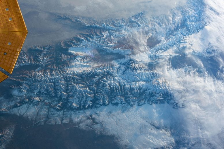 Clouds Blend With the Snow-Capped Tian Shan Mountain Range From ISS