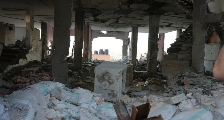 The inside of a destroyed building is filled with rubble.