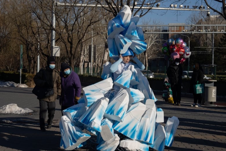 A Chinese artist wears as outfit to raise awareness of global warming. 