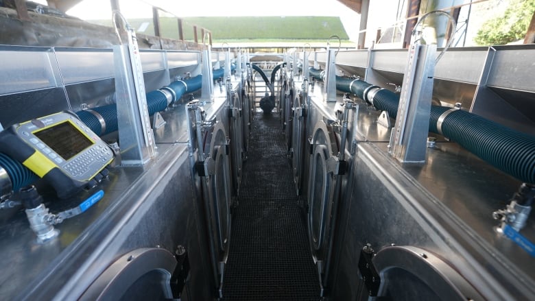 A lines of metal chambers are seen on either end of an aisle.