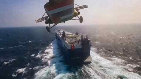 A photo published by Iranian-backed Houthis shows a helicopter approaching the ‘Galaxy Leader’ cargo ship in the Red Sea last month