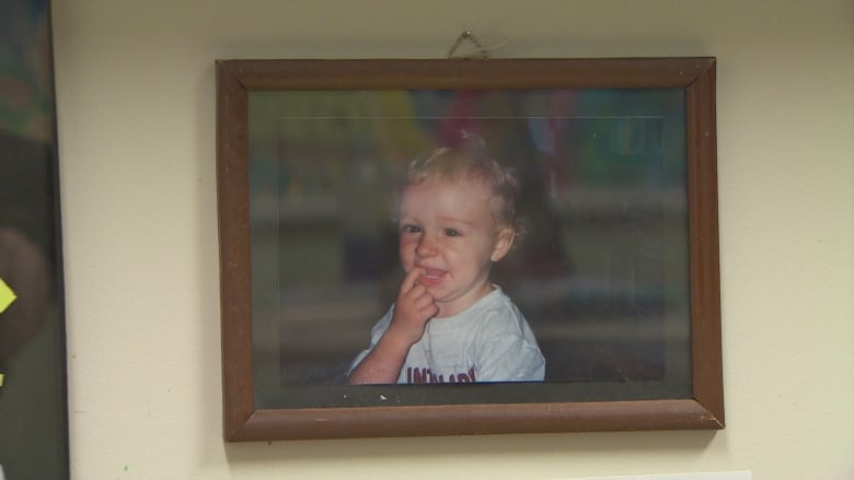 A picture of Shaymus when he was a child hangs in his mother's office. 