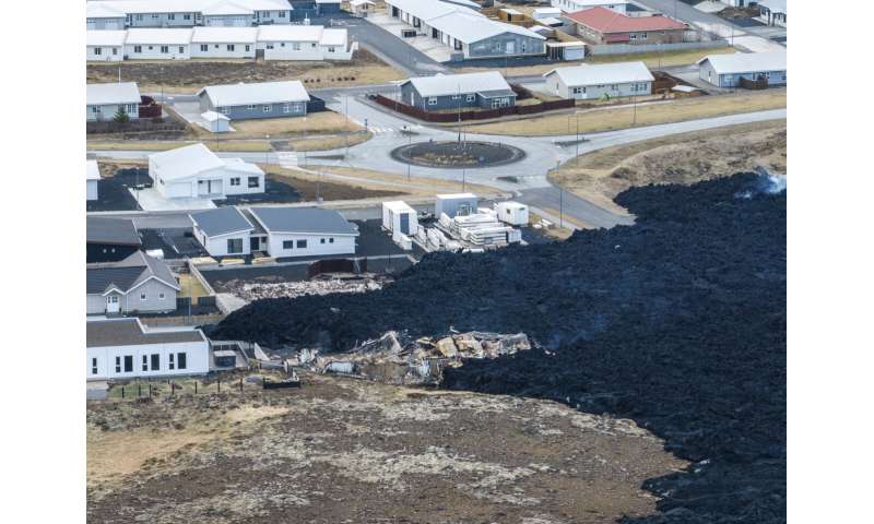 Iceland faces daunting period after lava from volcano destroys homes in fishing town, president says