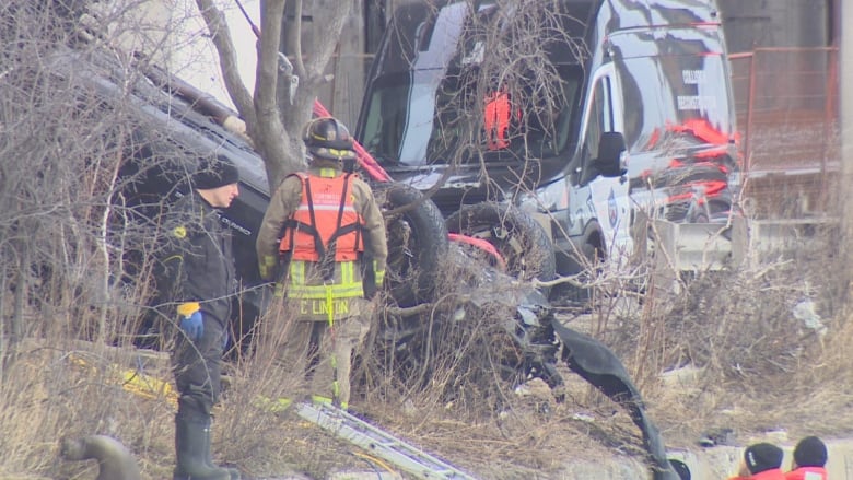 First responders and authorities work to extract a vehicle from a body of water, not pictured.