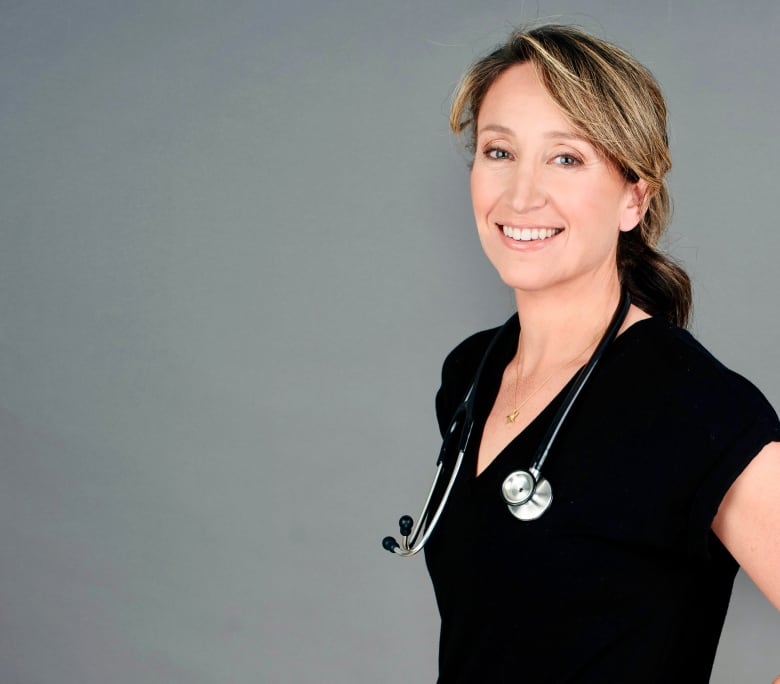 A photograph of a female doctor smiling at the camera. She has a stethoscope around her neck.