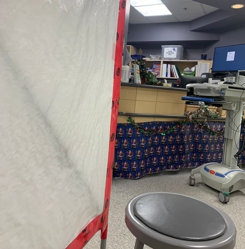 A photo of a tarp and a stool in a hospital emergency department.