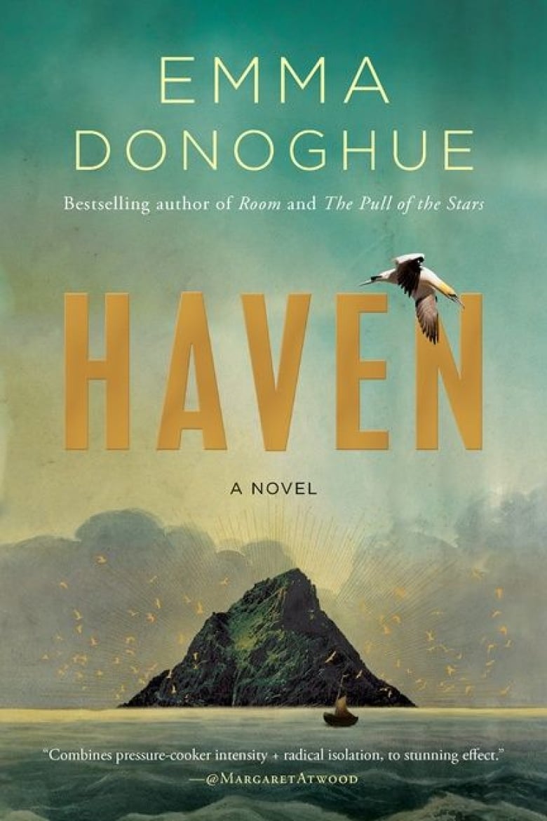 A book cover with gold writing and a photo of a mountainous island in the middle of the sea. 