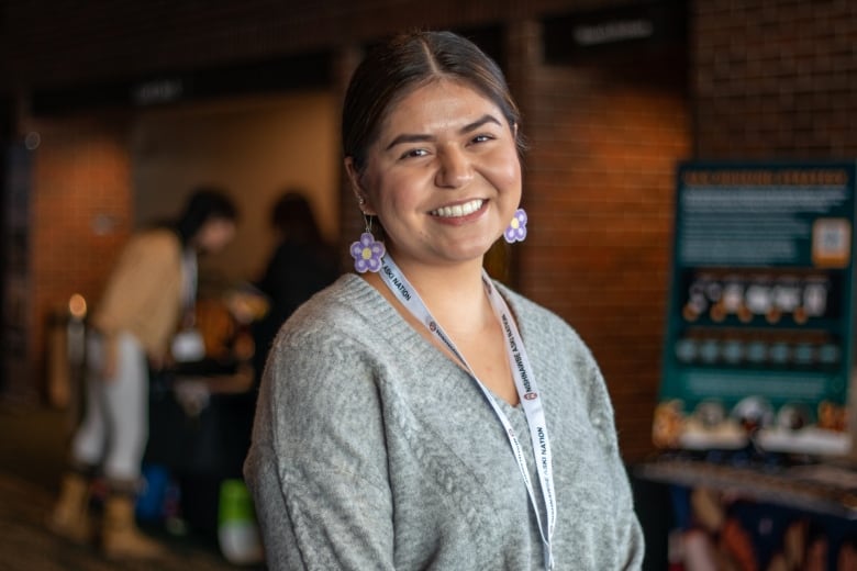 A young woman smiles as she poses for a portrait. 