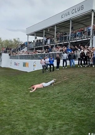 Fans enjoyed themselves by sliding down a muddy hill before it got shut down by police