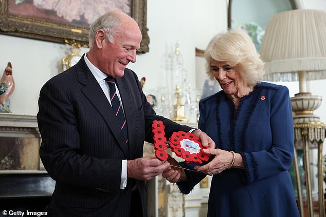 Camilla holds a '10' made out of popppies