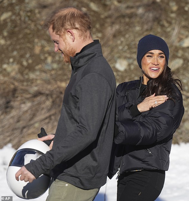 After going round for a second time yesterday, Harry made his way down the hill with Meghan