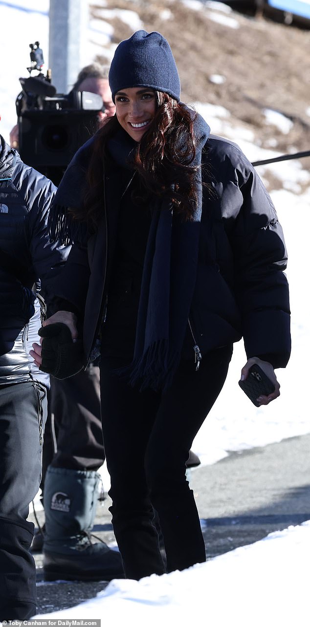 Meghan dressed for the cold weather, wrapped up warm in a scarf yesterday