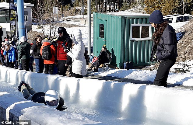 Meghan watched on as Harry tried his hand at skeleton bobsled yesterday