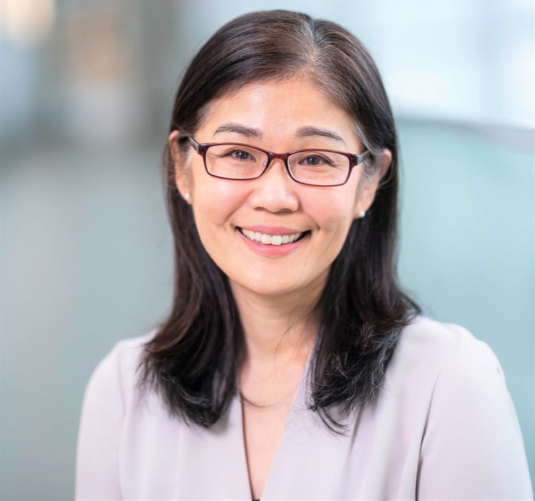 A woman smiles at the camera.