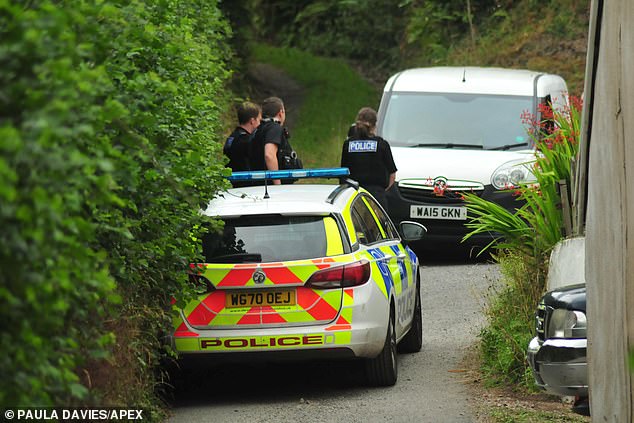 Police officers at the couple's home on August 28 2022 after Mr Rawley was allegedly stabbed