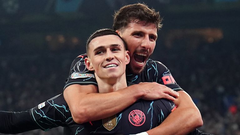 Phil Foden celebrates scoring Man City's late third goal with Ruben Dias