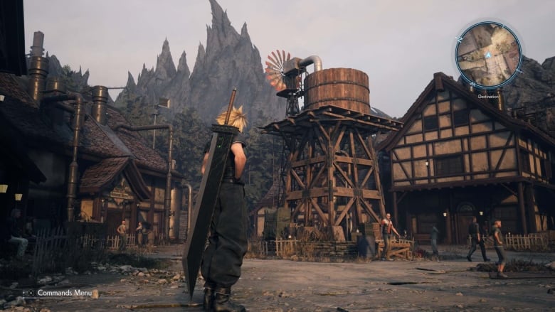 Video game screenshot of a man with a large sword on his back standing in a small village town square.