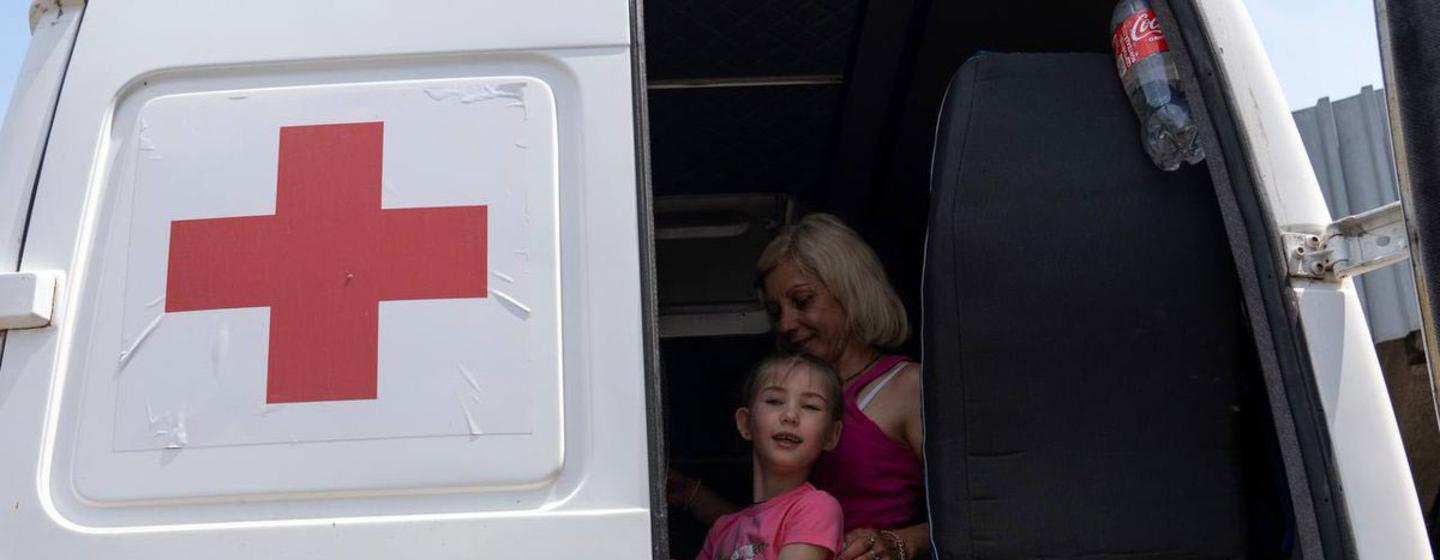 A family receives medical treatment in Odesa after being resuced in Kherson following the destruction of the Kakhovka dam.