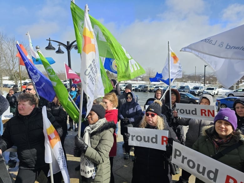 People holding signs that says 'proud' 