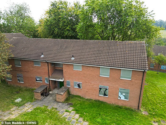 Metal boards placed in the windows of the abandoned estate have been smashed in, as locals complain vandalism in running rife in the area