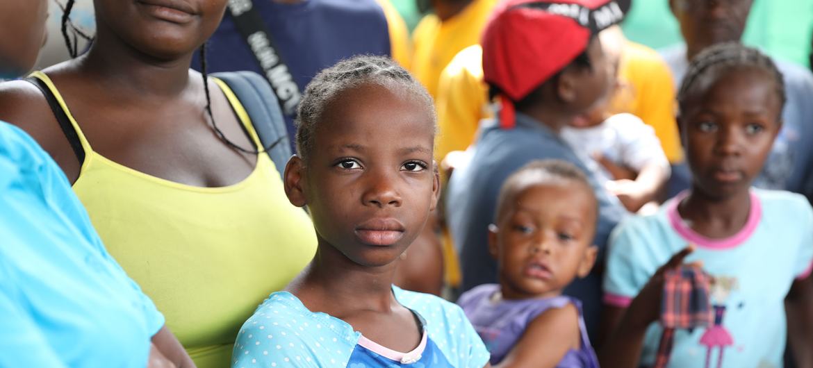 Families gather at a site for displaced persons in Tabarre, Haiti.