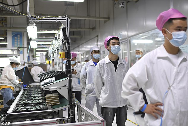 Workers line up to get tested for COVID-19 at the Foxconn factory in Wuhan in central China's Hubei province on Aug. 5, 2021