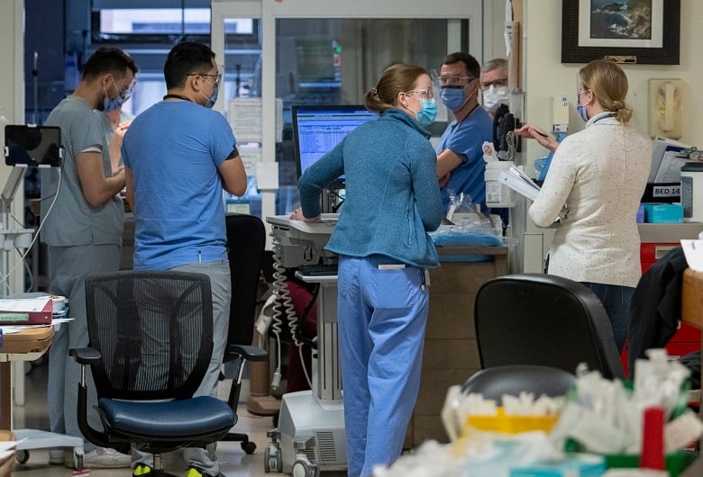 Doctors and nurses meet in a hospital.