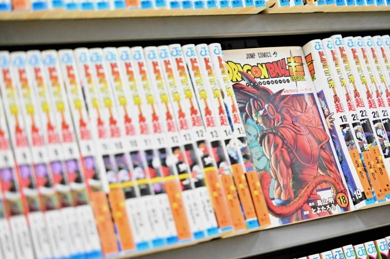 A closeup of a bookshelf is shown with copies of a comic-type book.